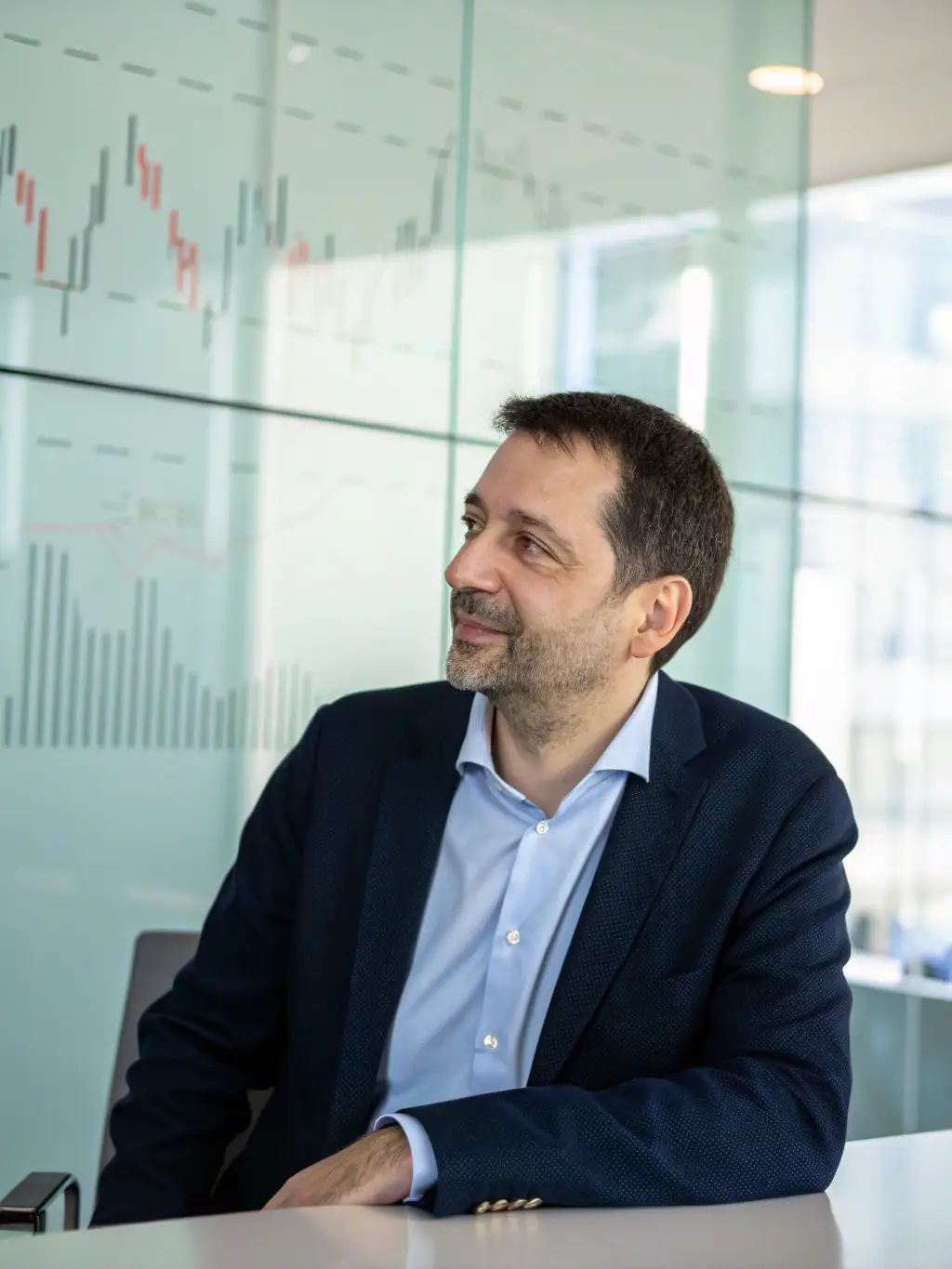 A consultant in a business setting, advising on IT strategy, with charts and data visualizations in the background, illustrating CLYCODE's ability to provide expert guidance and optimize technology solutions for businesses.